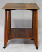 A mid century figured walnut occassional table with shaped supports united by undertier. H.61 W.50
