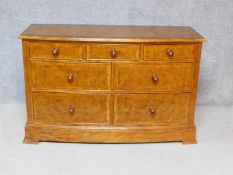 A Georgian style burr elm and crossbanded bowfronted chest of drawers on bracket feet, by Frank