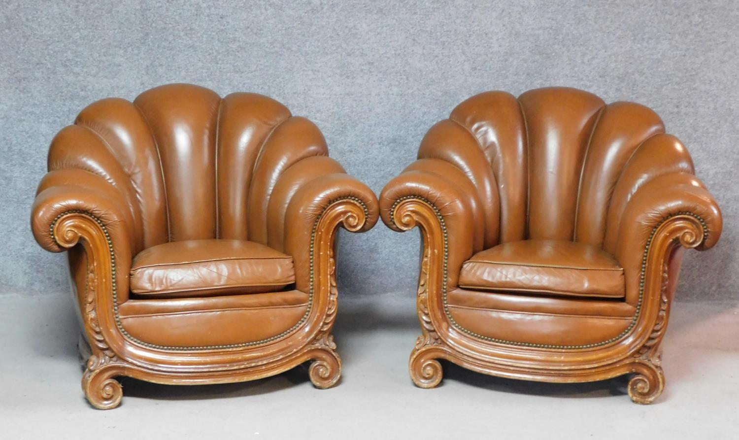 A pair of Italian walnut framed Arredo style armchairs in tan leather scalloped upholstery. H.80 W.