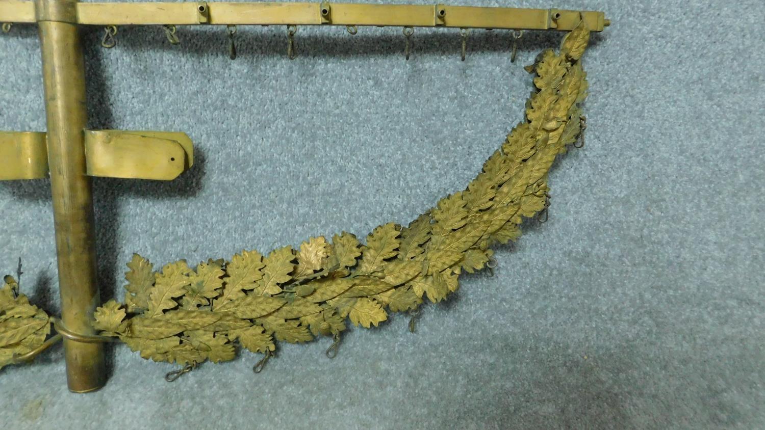 An antique gilded brass bracket with individual oak leaf decoration and hanging clip hooks. H.36 W. - Image 2 of 3