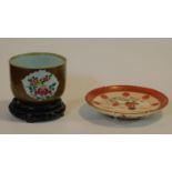 A 19th century Batavian porcelain bowl with floral design sitting on carved pierced wooden base,