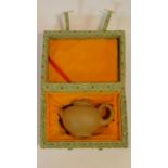 A patterned cased modern Yixing yellow clay teapot with goose/duck form finial and scroll form