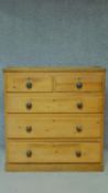 A Victorian pine chest of two short over three long graduated drawers on plinth base, fitted with