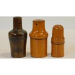 A collection of three treen apothecary's bottle holders with turned screw tops and with their
