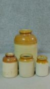Four antique glazed stoneware jars. H.42cm