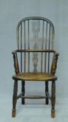 A 19th century elm hooped back Windsor armchair with pierced splat back and saddle seat on turned