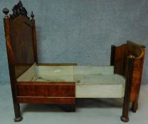 A 19th century French burr walnut nursing bed with floral carvings to the top and to the legs,