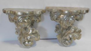 A pair of Rococo style gilded and silver finished wall sconces. 36x38cm