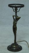 An Art Nouveau style brass and copper stretching nude lady table lamp on circular base. Stamped
