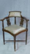 An Edwardian mahogany corner chair with lyre carved splats on turned stretchered supports. H.72cm