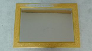 A bevelled plate wall mirror in floral gilt frame. 90x64cm