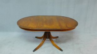 A Georgian style yew wood dining table with extra leaf on quadruped swept supports. H.73 W.160 D.