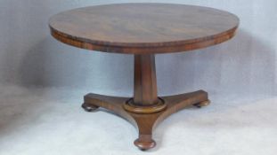 A 19th century mahogany tilt top table with facetted pedestal on tripod platform base. H.70 W.120