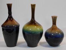 A collection of three Persian drip glazed vases of bulbous form. H.34cm