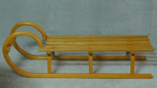 A German laminated beech wood sleigh by Ress Rodel in the vintage style with makers mark. H.37 W.116