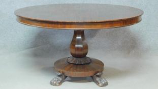 A William IV mahogany tilt top dining table with facetted bulbous pedestal on platform base