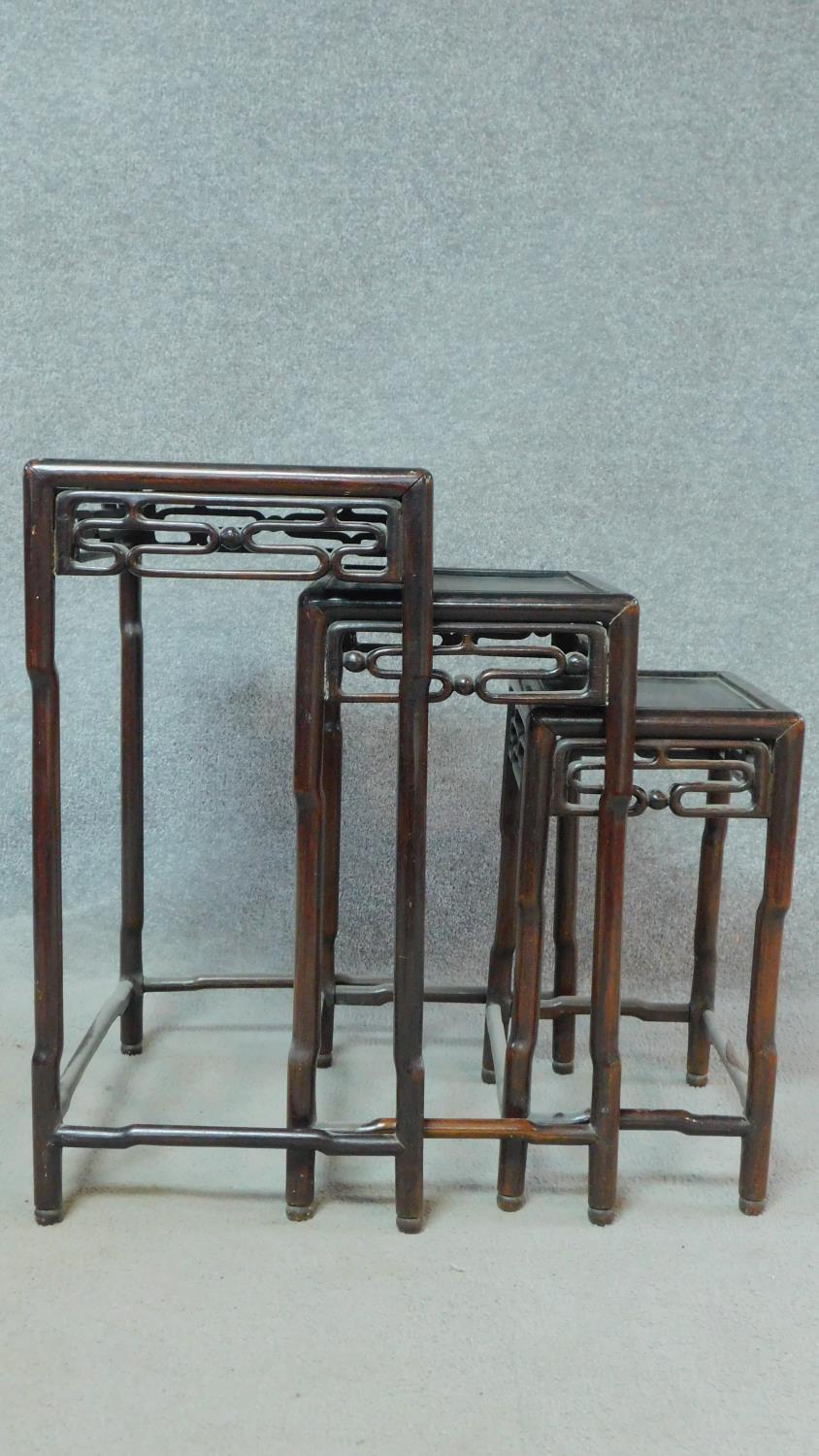 A nest of three Chinese hardwood occasional tables of graduating size with pierced frieze on - Image 3 of 4