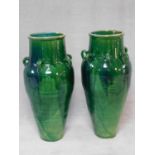 A pair of large floor standing turquoise drip glazed Sharab wine vessels of bulbous form with