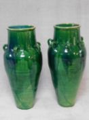 A pair of large floor standing turquoise drip glazed Sharab wine vessels of bulbous form with