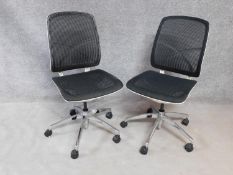 A pair of contemporary swivelling adjustable office desk chairs with mesh backs and seats. H.100cm