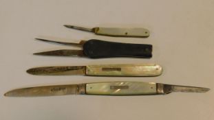 A collection of antique pocket knives. Including two mother of pearl handled silver fruit knives,