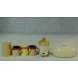 A miscellaneous collection of glazed stoneware pottery to include a foot warmer a jug and three
