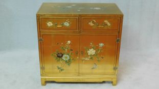 A painted and lacquered Japanese cabinet decorated with birds and flowers on a gilt background. H.91
