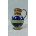A Doulton Lambeth stoneware glazed Victoria diamond jubilee jug, with a scroll handle and two bands,