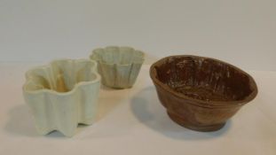 A large Victorian brown lustre stoneware glazed jelly mould with grape and vine leaf design, stamped