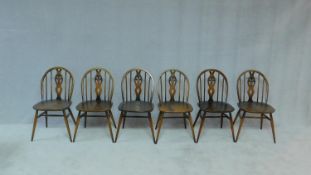 A set of six elm and beech Ercol Windsor wheel back dining chairs with makers label and kite mark