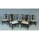 A set of eight Chinese hardwood dining chairs with carved splat backs and fitted squab cushions on