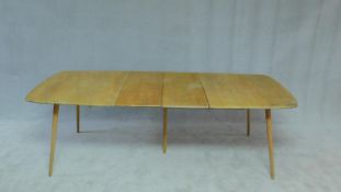 A vintage Ercol blonde elm and beech dining table with extra leaf. H.70 W.240 D.77cm