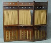 A late 19th century mahogany Art's and Crafts style three section screen with pierced panels and