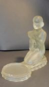 An Art Deco frosted glass sculpture of a kneeling woman offering a bowl with circular platform.