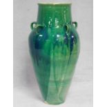 A large floor standing turquoise drip glazed Sharab wine vessel of bulbous form. H.90cm