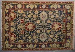 A pure wool Agra design carpet with allover lotus flower and scrolling meandering vine decoration on