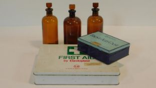 Three 19th century brown chemists/pharmacy bottles along with two vintage first aid cases. One by