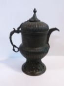 An 18th century Islamic pierced and engraved bronze samovar. Animal form handle and stylized