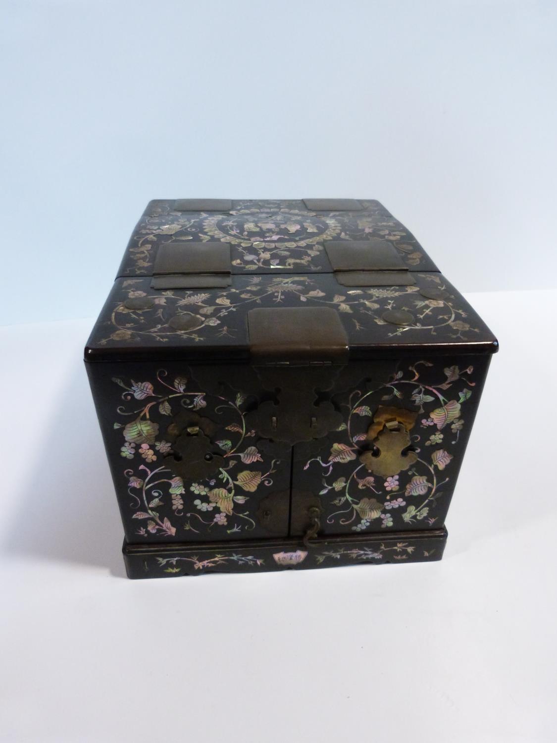 A 19th century Chinese rosewood travelling vanity box decorated with inlaid mother of pearl figures,