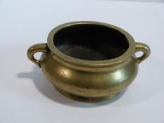 A 19th century Chinese twin handled footed brass censer. Ming mark to base. Diameter 12cm, 17cm with