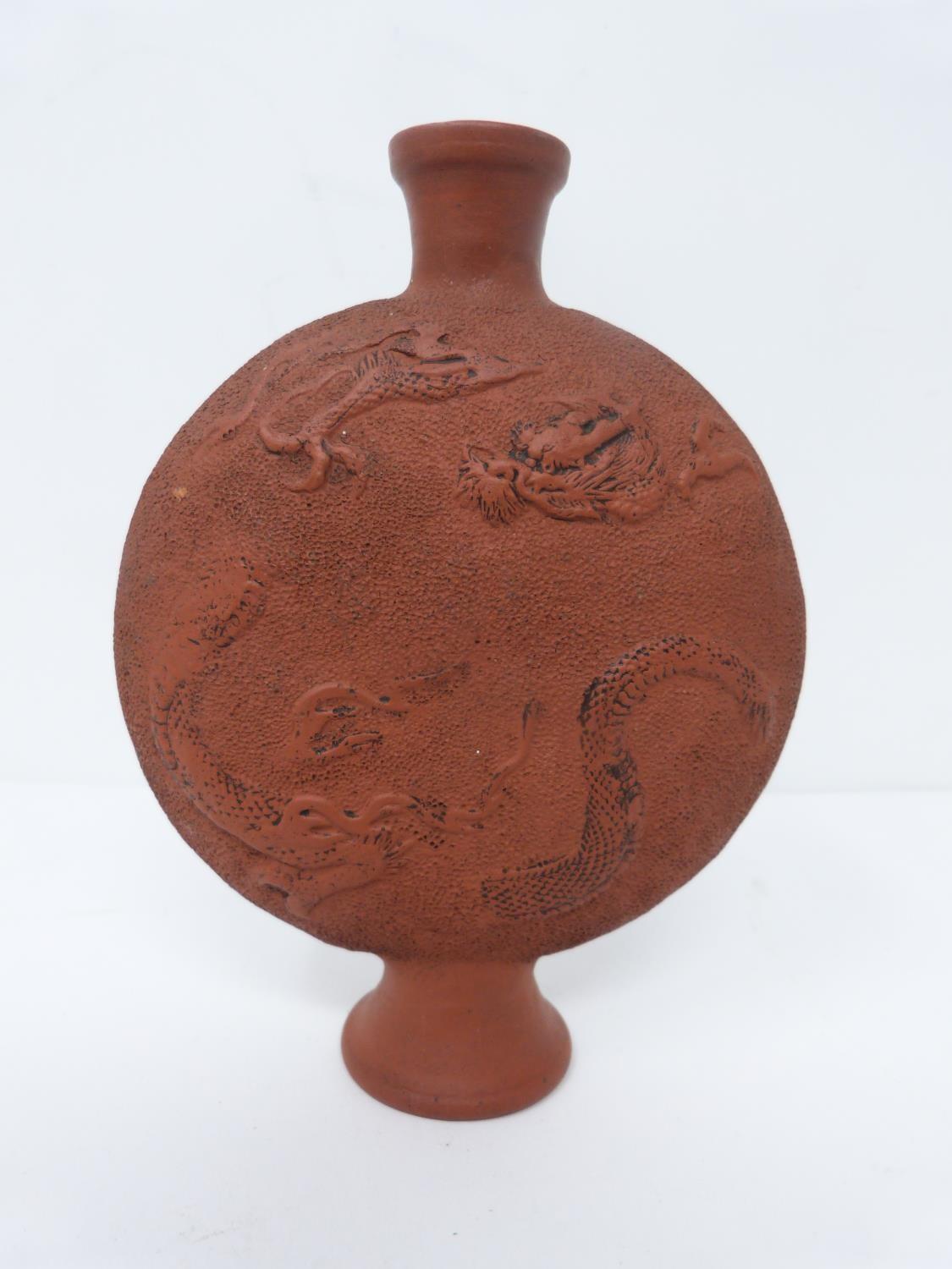 A late Meji -Taisho period unglazed terracotta dragon design moon flask. h11cm