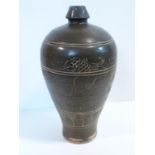 A 19th century Chinese Cizou ware type glazed pottery vase with fish and scrolling motif design.