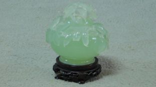 A 20th century serpentine jade lidded censer on a footed pierced carved hardwood base. The censer is