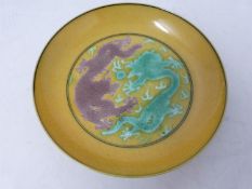 A Kangxi style porcelain golden-yellow ground Dragon dish, six-character Guangxu mark. Grape