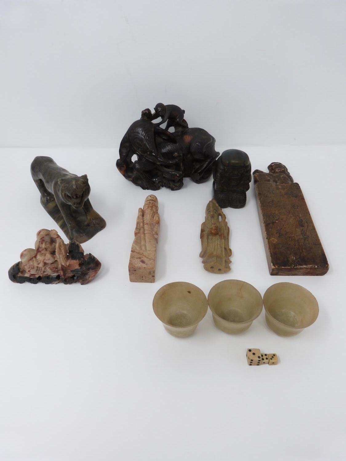 A collection of Chinese soapstone and other items. Including a brass weight in the form of a boy,
