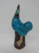 A turquoise and purple glazed Kangxi style porcelain rooster with makers seal stamp to base. h21cm