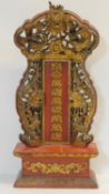 A Qing dynasty Chinese lacquered and gilt carved and pierced ancestral altar decorated with dragons,