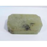 A 20th century Chinese lidded rectangular jade box, the top carved in low relief with three
