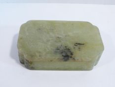 A 20th century Chinese lidded rectangular jade box, the top carved in low relief with three