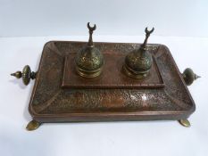 A 19th century Qajar repousse design copper and brass ink stand. Decorated with men on horse back,